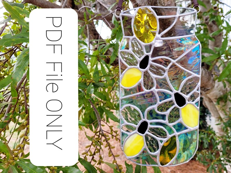 May include: Stained glass jar-shaped suncatcher with a floral design. The jar features yellow and black flower accents, with a clear and iridescent glass background. A brown leather cord is attached for hanging. The text "PDF File ONLY" is on a white background.
