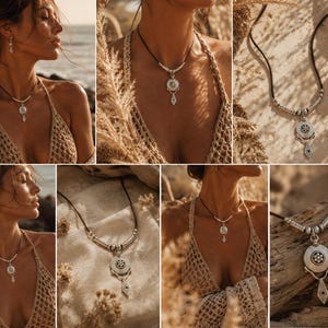 May include: A silver pendant necklace featuring a circular centerpiece with a floral motif, suspended from a dark cord with silver accents. The pendant includes a dangling geometric element with a small dark stone, creating a layered look.