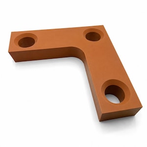 May include: A terracotta-colored, L-shaped object with three circular indentations. The object has a smooth, matte finish and is set against a white background. The design is modern and minimalist.