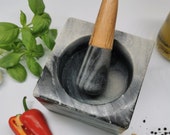 Handcrafted mortar and pestle. Black marble and acacia wood. Stunning, contemporary design.
