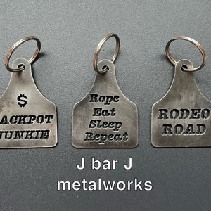 cattle tag keychain with cowboy saying cutouts.