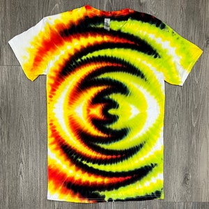 May include: A tie-dye t-shirt with a yellow, orange, red, black and white swirl pattern.