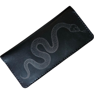 May include: A rectangular black leather wallet featuring a light gray engraved snake design on the front surface. The wallet has visible stitching along the edges and a smooth, matte finish, showcasing a detailed scale pattern on the snake.