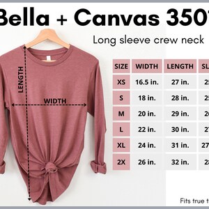 May include: A size chart for a long-sleeved crew neck t-shirt. The chart shows the width, length, and sleeve length in inches for sizes XS to 2X. The text "Bella + Canvas 3501" and "Fits true to size" are also visible.