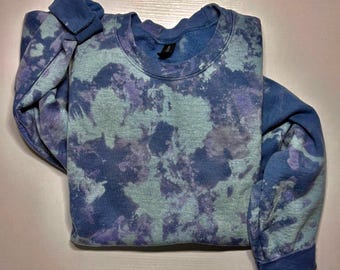 May include: A blue tie-dye sweatshirt with a light blue and purple pattern.