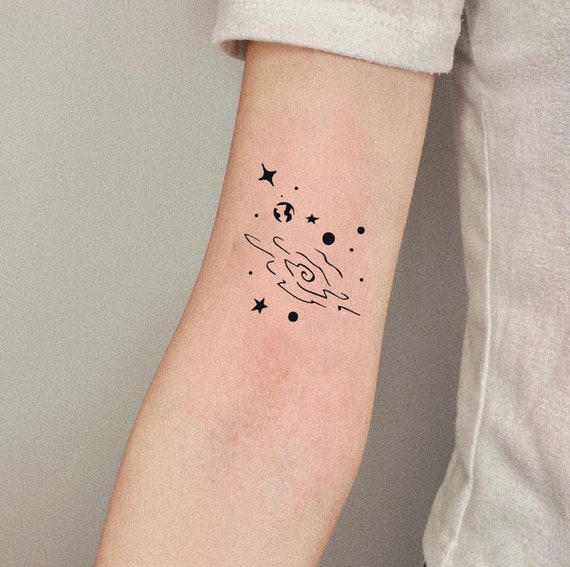 Tiny galaxy tattoo done on the wrist minimalistic