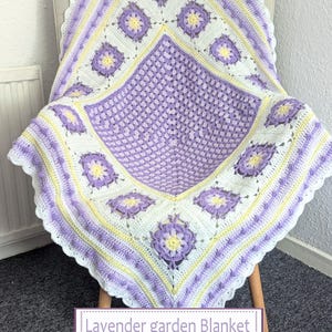 May include: A lavender, white, and yellow crochet blanket with a floral pattern, draped over a chair. The blanket features a central lavender square, surrounded by white and yellow accents. The text "Lavender garden Blanket Crochet pattern" is visible.