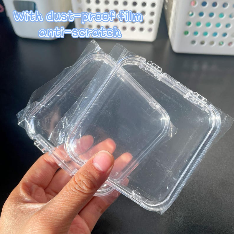 May include: Two clear plastic square cases with a protective dust-proof film and anti-scratch coating. The cases are stacked on top of each other.