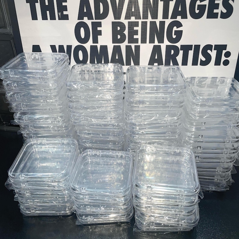 May include: A stack of clear plastic square containers. The containers are stacked on top of each other and are all the same size. The containers are made of a clear plastic material and have a smooth surface. The containers are empty and are ready to be used.