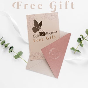 May include: A light brown envelope with a beige card inside. The card has a butterfly graphic and the text "Gifts N Surprise Free Gift" and "Jewelstone Design".