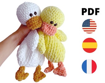 May include: Two crocheted duck plushies, one white and one yellow, with pink beaks and brown eyes. The plushies are made with a fluffy yarn and have a soft, cuddly texture. PDF.