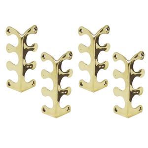 May include: Set of four brass corner brackets with three holes each. The brackets are designed to be mounted on a wall or other surface and have a decorative, ornate design.
