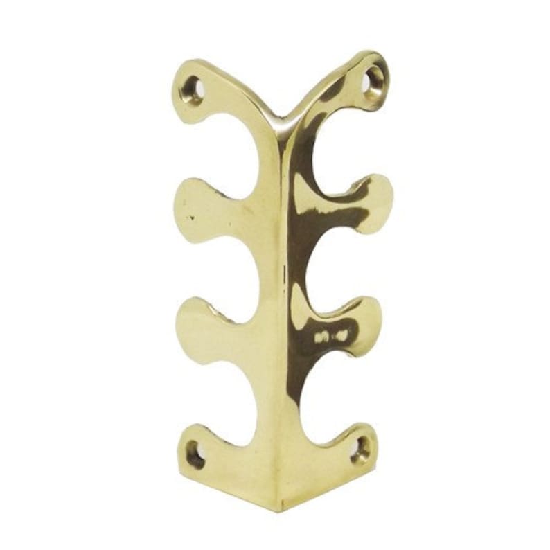 May include: Brass corner bracket with three holes on each side. The bracket is designed to be used in a corner and has a decorative design.