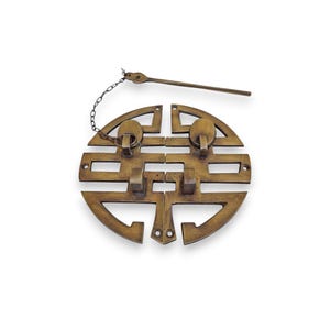 May include: A bronze-colored, decorative cabinet pull with a double happiness symbol design. The pull features a circular shape with two handles and a matching key and chain. The hardware is made of metal and is likely for a cabinet or drawer.