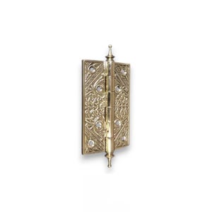May include: A decorative brass hinge with an ornate floral pattern. The hinge is rectangular with rounded edges and a central pin. The brass has a polished finish, and the hinge is designed for a door or cabinet.