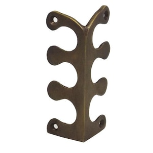 May include: Brass corner bracket with three decorative cutouts. The bracket is a right angle and has a smooth, polished finish.