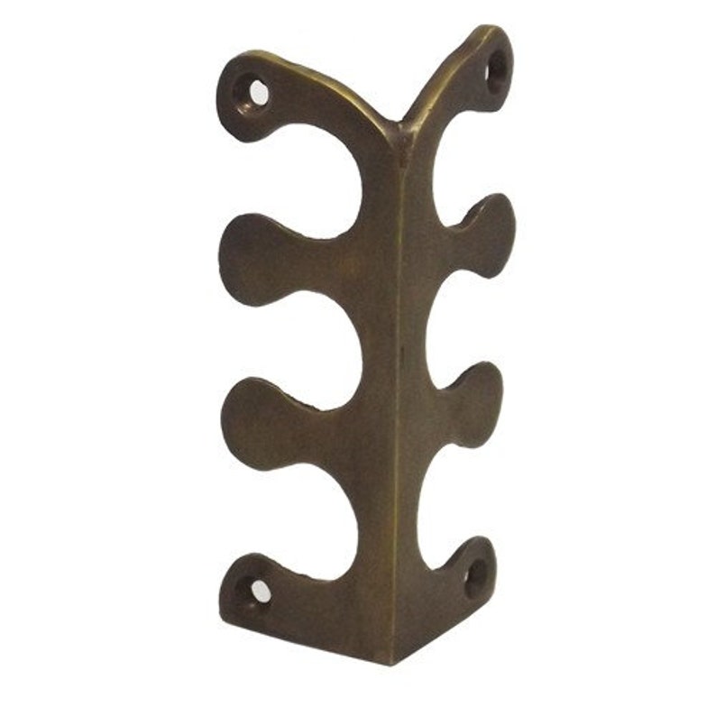 May include: Brass corner bracket with three decorative cutouts. The bracket is a right angle and has a smooth, polished finish.