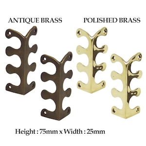 May include: Two corner brackets, one in antique brass and one in polished brass, each with three decorative loops. The brackets are 75mm high and 25mm wide.