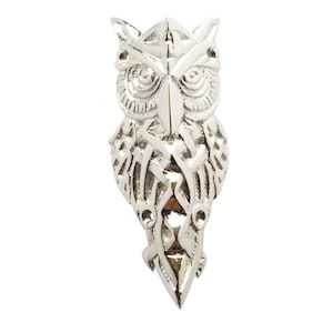 May include: A silver owl pendant with intricate Celtic knotwork design. The owl's eyes are detailed and the pendant has a pointed tail.