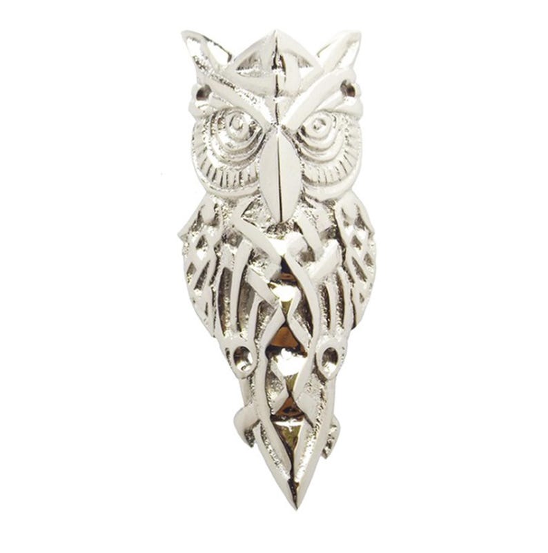 May include: A silver owl pendant with intricate Celtic knotwork design. The owl's eyes are detailed and the pendant has a pointed tail.