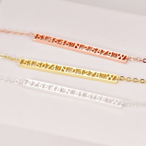 May include: Three gold bar necklaces with numbers 1 through 9 cut out of the bars. The necklaces are in rose gold, yellow gold, and silver.