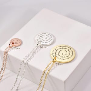Puede incluir: Tres collares con colgantes en oro rosa, plata y oro. Cada colgante circular tiene una cita inspiradora. El colgante de oro rosa mide 12 mm, el de plata 20 mm y el de oro 25 mm. Cada collar tiene una cadena delicada.