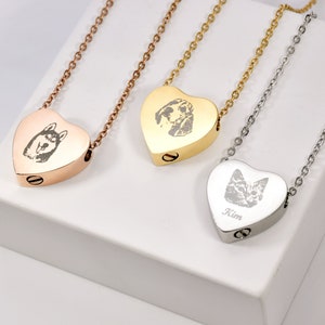 May include: Three heart-shaped pet memorial necklaces in rose gold, gold, and silver. Each pendant features a pet portrait and hangs from a matching chain. The silver necklace has the name "Kim" engraved on it.