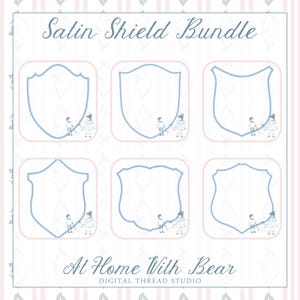 May include: A digital design featuring six shield shapes in a light blue outline, each set within a pink square. The text "Satin Shield Bundle" is at the top, with "At Home With Bear" and "Digital Thread Studio" at the bottom.