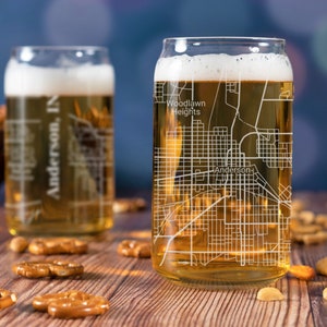 May include: Two clear glass beer mugs with a city map design. The mug on the right has the text "Woodlawn Heights" and "Anderson" on the map. The mug on the left has the text "Anderson, IN" on the map.