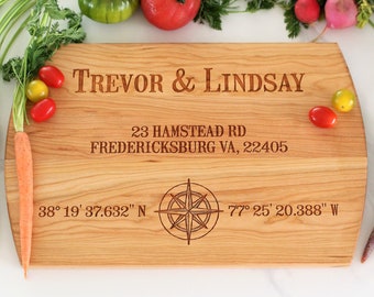 May include: Personalized wooden cutting board with the names Trevor & Lindsay, address 23 Hampstead Rd Fredericksburg VA, 22405, and coordinates 38° 19′ 37.632" N 77° 25' 20.388" W.