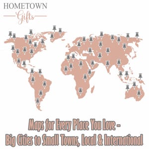 May include: A world map graphic in a muted rose color featuring numerous grey push pins scattered across various continents. The text HOMETOWN Gifts appears at the top, and the text Maps for Every Place You Love - Big Cities to Small Towns, Local & International is at the bottom.