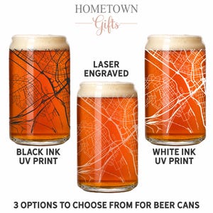 May include: Three clear glass beer cans filled with amber liquid and foam. The left glass features a black ink UV printed map, the center glass has a laser engraved map, and the right glass displays a white ink UV printed map. Text reads HOMETOWN Gifts.