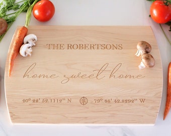 May include: A wooden cutting board with the text "THE ROBERTSONS home sweet home 40° 22' 52.1112" N 79° 48' 42.8292" W" engraved on it.