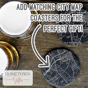 May include: Black slate coasters with a white city map design. The coasters feature the text "Old Greenwich" and "Riverside". The text "Add matching city map coasters for the perfect gift!" is displayed above the coasters.