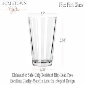 May include: A clear 16oz pint glass with a tapered shape. Dimensions are 3.5 inches in diameter at the top, 2.38 inches at the base, and 5.88 inches in height. Text includes HOMETOWN Gifts, 16oz Pint Glass, Dishwasher Safe, Chip Resistant, Lead Free.