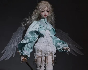 May include: A porcelain doll with long blonde hair wearing a light blue and white outfit with a sword. The doll has wings and is wearing white thigh-high boots.