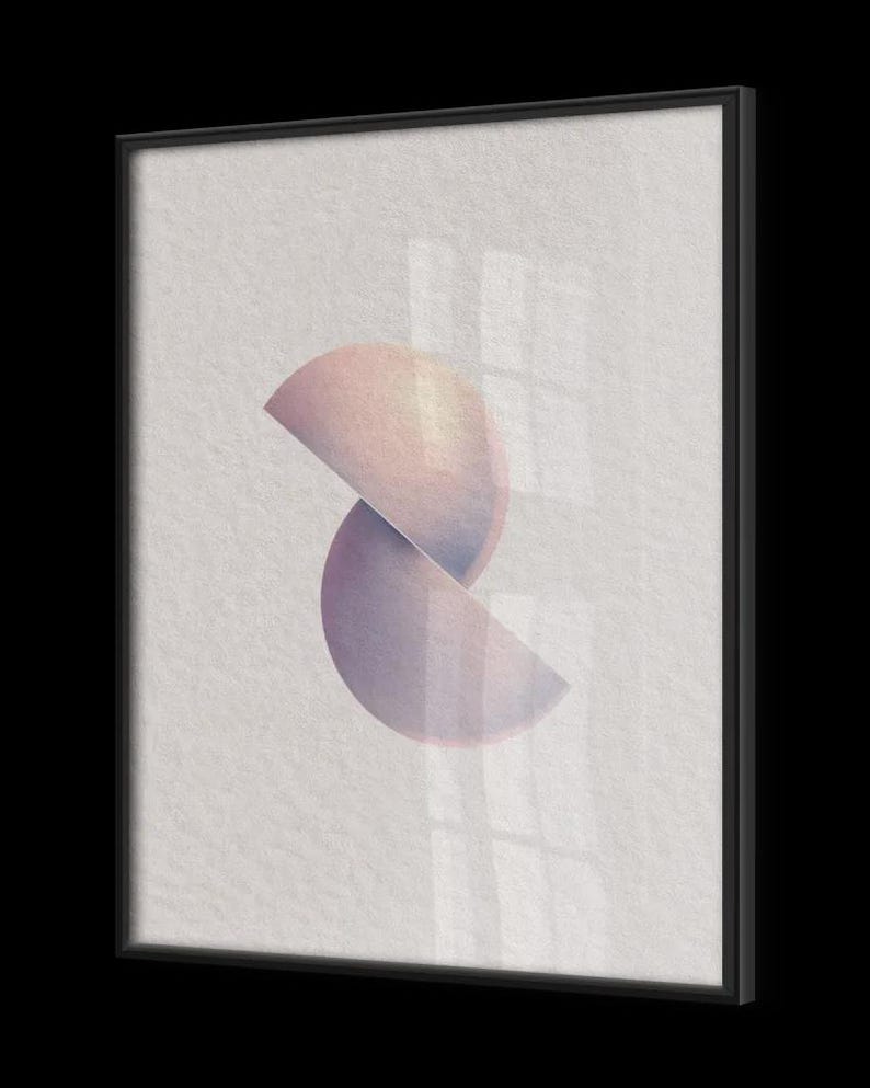 Puede incluir: Impresi&oacute;n art&iacute;stica abstracta con dos formas semicirculares superpuestas en tonos rosa y morado. La obra de arte est&aacute; enmarcada en un marco negro rectangular, creando una est&eacute;tica moderna y minimalista. El fondo es una superficie clara y texturizada.