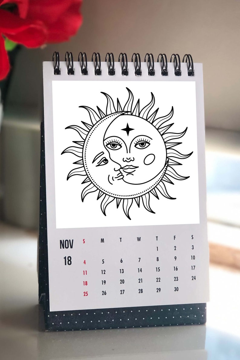 May include: A black and white illustration of a sun and moon with a face on each. The sun has a star on its forehead. The image is on a calendar page for November 18th.