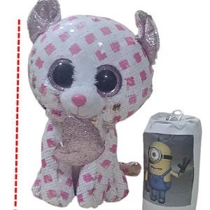 May include: A white and pink plush toy cat with large, glittery eyes. The cat is 9 inches tall and has a checkered pattern on its body.