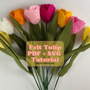 Peut inclure: Un bouquet de tulipes en feutre de différentes couleurs, dont le jaune, l'orange, le rose, le blanc et le rouge. Les tulipes sont disposées dans un vase avec des feuilles en feutre vert. Le texte "Felt Tulip PDF + SVG Tutorial" est affiché sur un rectangle rose.