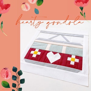 Könnte beinhalten: Ein roter und weißer Patchwork-Quiltblock mit einer Herzform in der Mitte. Der Block ist von einem weißen Rand umgeben und der Text "hearty gondola" steht darüber.