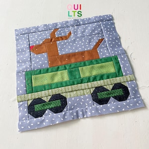 May include: A brown reindeer pulling a green wagon with black wheels on a blue background with white polka dots. The wagon has a green and white striped border. The reindeer has a red nose. The text "OUI LTSS AND NICE STUFF" is at the top of the image.