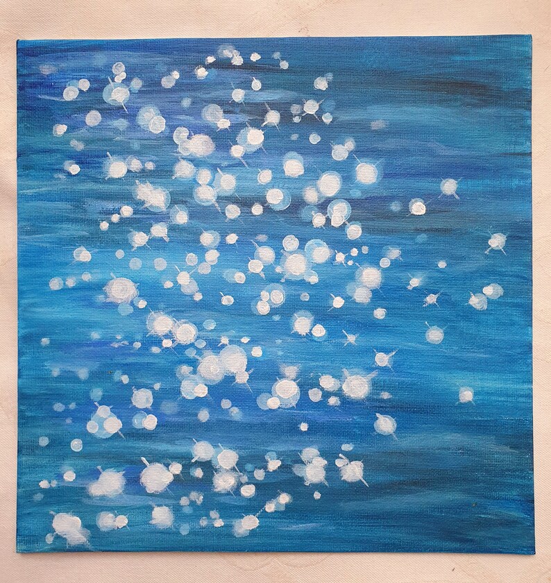 May include: An abstract painting on canvas featuring a deep blue background with white, circular, and star-like shapes. The artwork evokes a sense of depth and movement, resembling light reflecting on water.