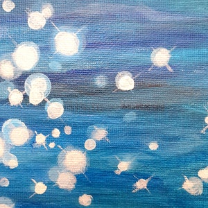 May include: Abstract painting with a textured canvas. The artwork features a gradient of blues, with white, circular, and star-like shapes scattered across the surface. The painting evokes a sense of depth and movement.