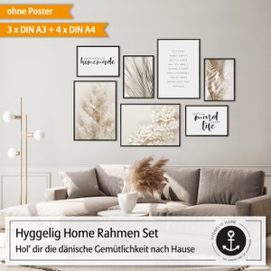 May include: A set of seven framed prints with a neutral color palette. The prints feature text and abstract botanical illustrations. The prints are arranged on a wall above a beige couch. The text on the prints reads "Happiness is homemade", "Life is not always perfect but it's always what you make it. So make it count and make it memorable. And let never anyone steal your happiness", "Happy mind happy life", and "Hyggelig Home The Danish Art of Happiness".