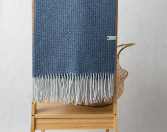 Cashmere and merino throw in blue, with fringes on short sides. Merino and cashmere throw blanket. Sofa plaid.