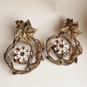 Liberty decorations in metal and ceramic. Two decorative hooks in finely crafted metal and ceramic. Liberty style metal decorations.