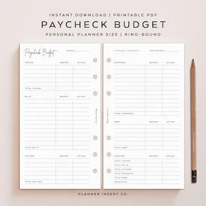 May include: A printable PDF paycheck budget planner with a ring-bound design. The planner includes sections for income, bills, savings, and expenses. A pencil rests on the right side of the planner. The text "Paycheck Budget" is at the top.
