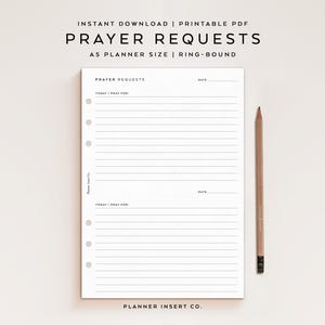 May include: A white A5 planner insert for prayer requests with black text and lines. The page features two sections labeled PRAYER REQUESTS, TODAY I PRAY FOR, and DATE, with six circular holes on the left side for ring binding and a wooden pencil.