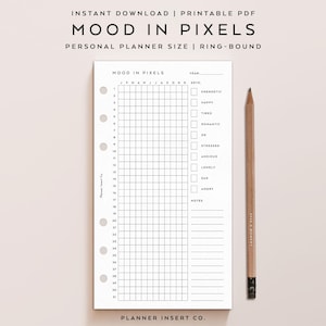 May include: A printable PDF planner insert titled "Mood in Pixels" with a grid for tracking daily moods. The planner includes a section for notes and a wooden pencil. The text "Planner Insert Co." is visible.